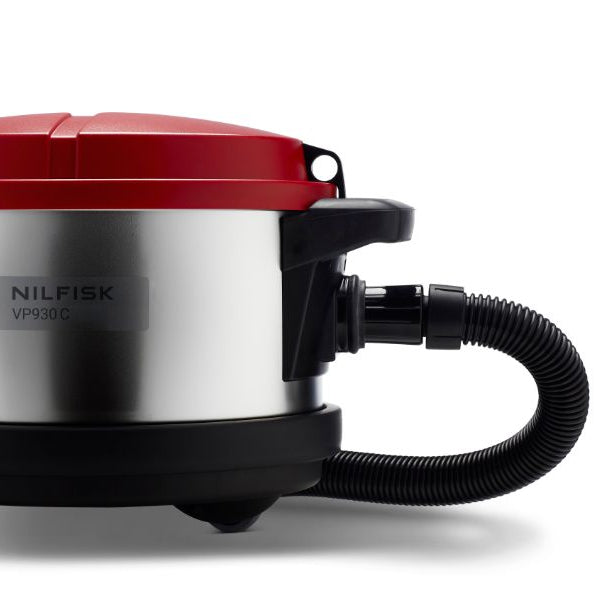Red and silver cylinder vacuum cleaner by Nilfisk with black accents, hose, and wheels shown in a side view.