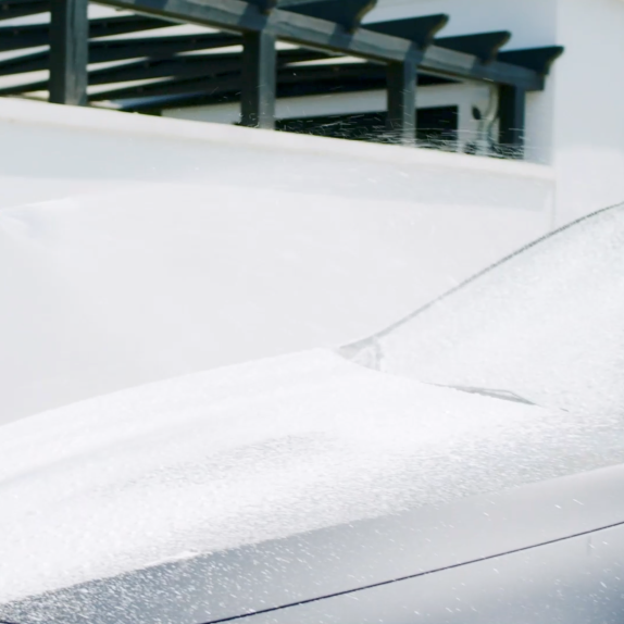 Snow foam cleaner, 500 ml, being sprayed onto a car.