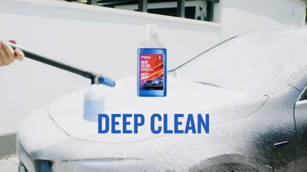 Car wash shampoo, Deep Clean by Nilfisk, shown during use on a wet car.