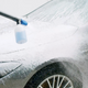 High-pressure cleaner detergent by Magic Wax being used on a gray car.
