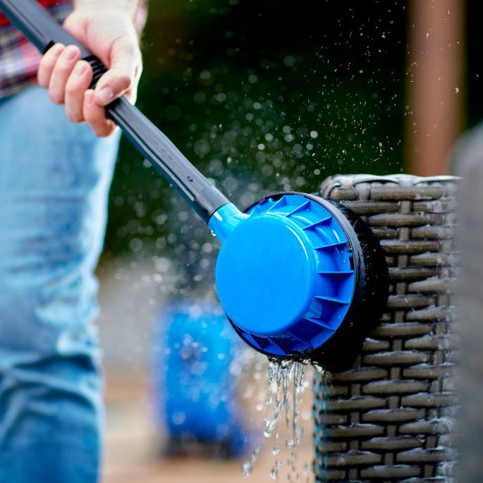 Rotary brush high-pressure cleaner accessory for high-pressure cleaners, cleaning a wicker furniture with running water.

