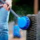 Rotary brush high-pressure cleaner accessory for high-pressure cleaners, cleaning a wicker furniture with running water.
