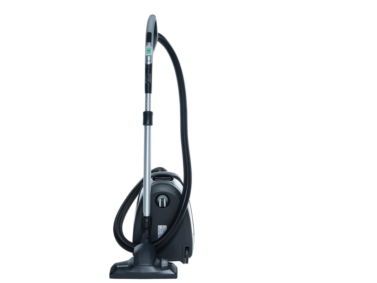 Black canister vacuum by Nilfisk with a hose and telescopic wand standing on a white background.