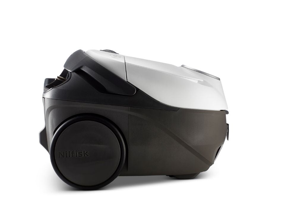 White vacuum cleaner by Nilfisk with dark gray accents and large wheels.