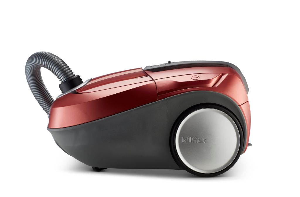 Red and gray vacuum cleaner by Nilfisk, featuring a curved hose and silver wheel cover.