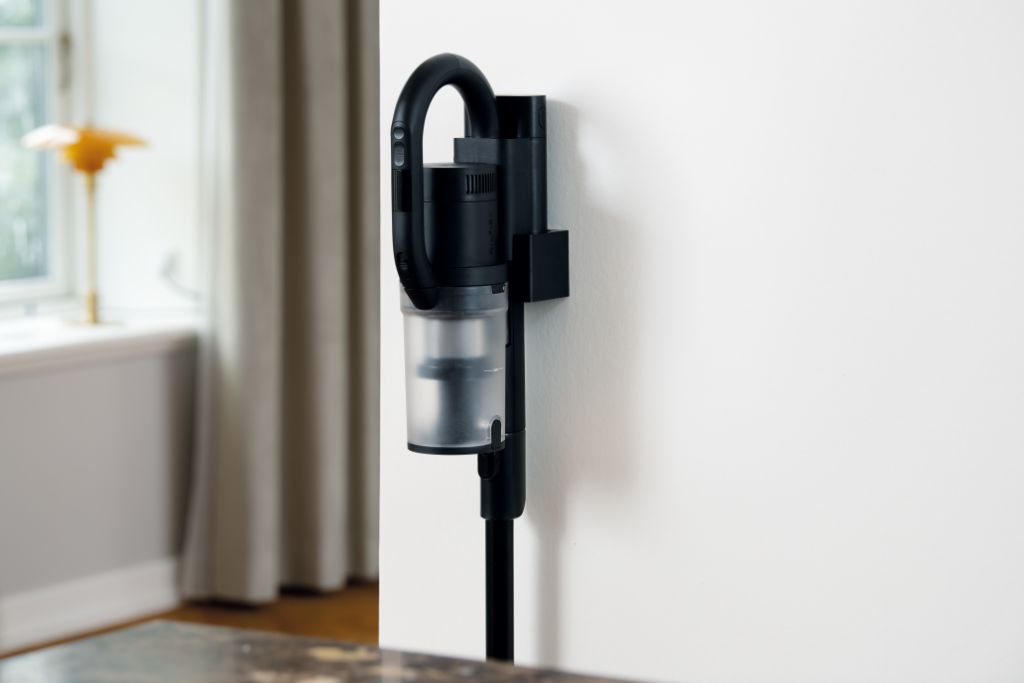 Vacuum cleaner accessory for S1 vacuum cleaners attached to a white wall.