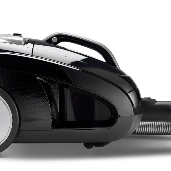 Black canister vacuum cleaner from Meteor with a silver wheel and chrome accents.