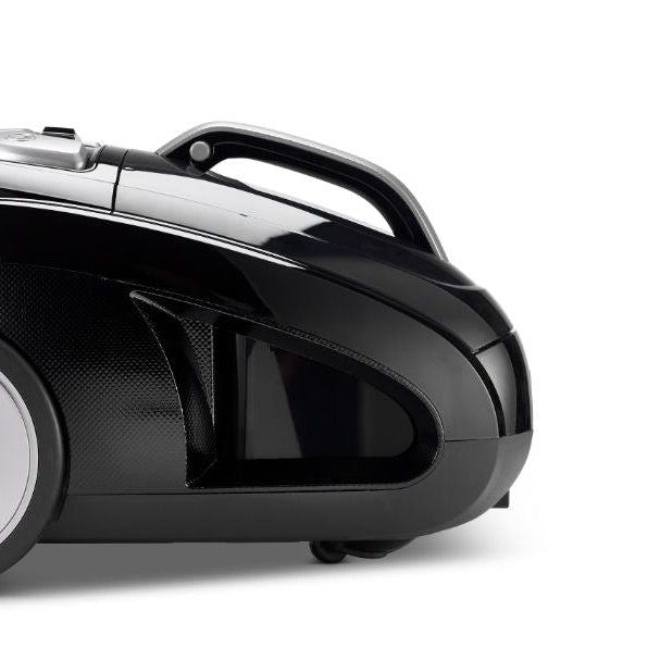 Black canister vacuum by Meteor, featuring silver accents and a round wheel, displayed in a side view.
