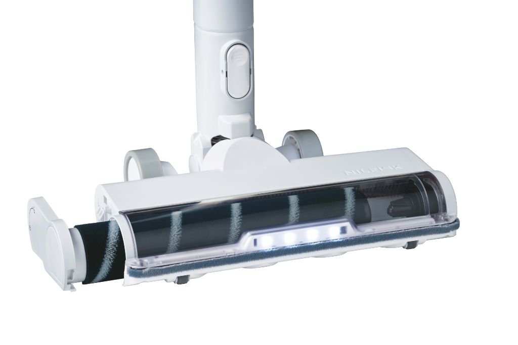 White cordless stick vacuum cleaner by Nilfisk with brush head and LED lights.