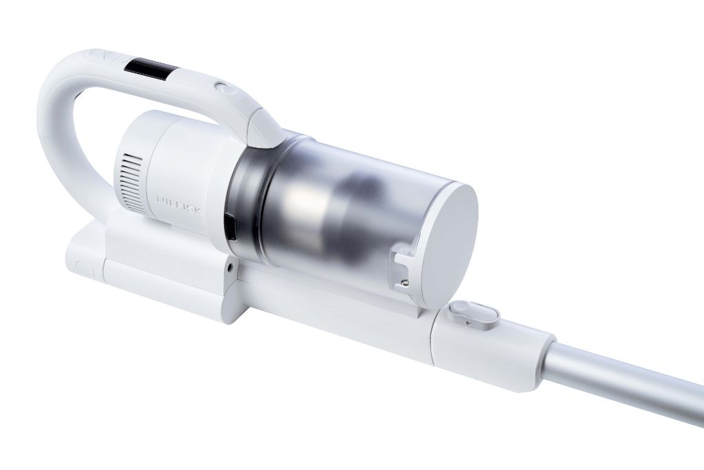 White cordless stick vacuum cleaner from Nilfisk with a clear dustbin and silver wand.