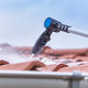 Roof cleaner attachment for pressure washers by Nilfisk cleaning a roof.