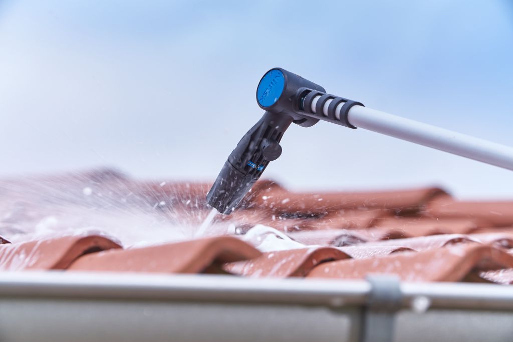 Roof cleaner attachment for pressure washers by Nilfisk cleaning a roof.