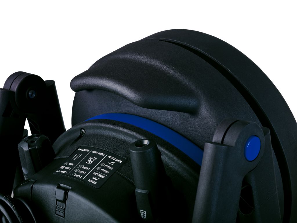 Black high-pressure washer with blue accent stripe and control panel, side view, featuring nozzle attachments and textured grip handles