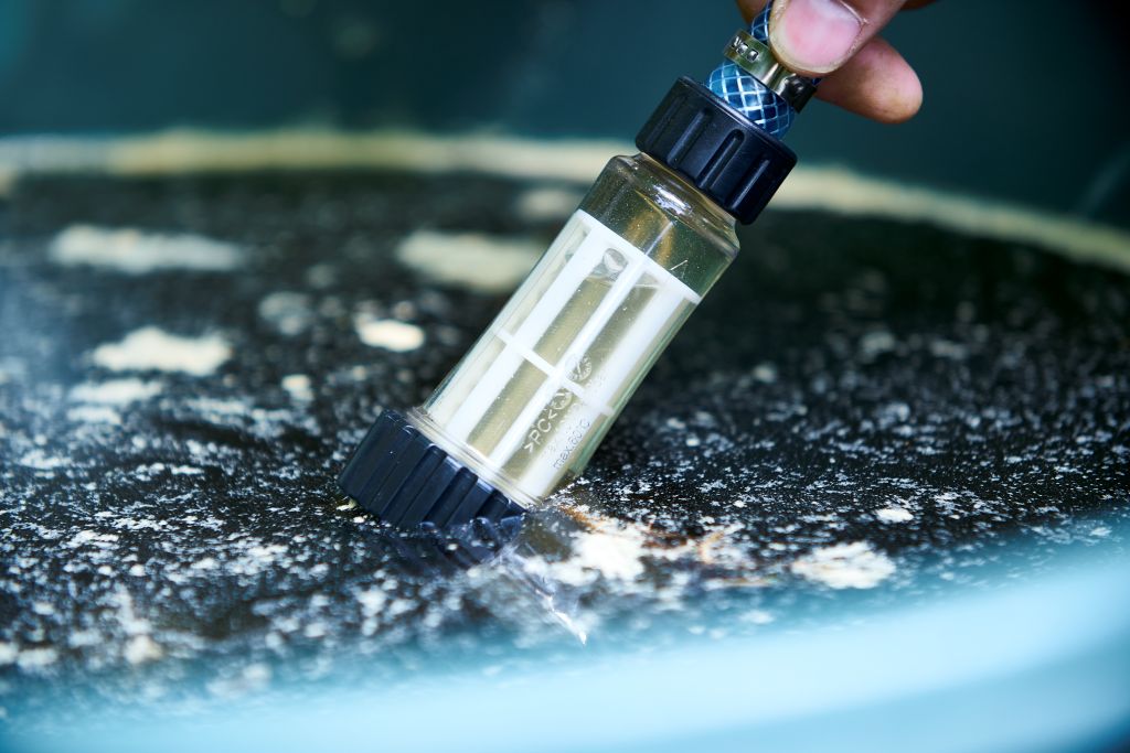High-pressure cleaner accessory filter for high-pressure cleaners, with a clear plastic housing and black caps.