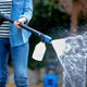 High-pressure cleaner detergent with soap dispenser, being used to clean a rattan chair.