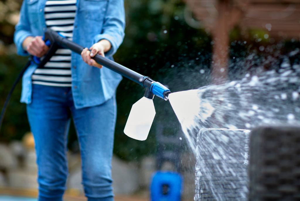 Pressure washer cleaner for rattan and plastic by ES spraying onto outdoor furniture.