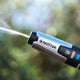 High pressure washer by Nilfisk with a silver spray head and a blue button.