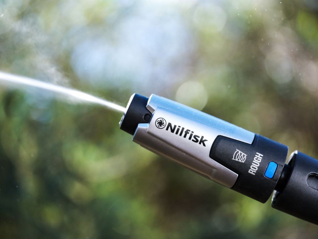 High pressure cleaner nozzle by Nilfisk, with rough mode selected, shown in a close up shot.