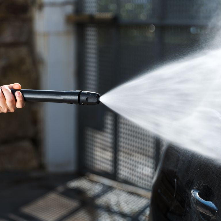 Pressure washer accessory for car and bike by ES, spraying water on a car.