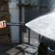 Pressure washer accessory for car and bike by ES, spraying water on a car.