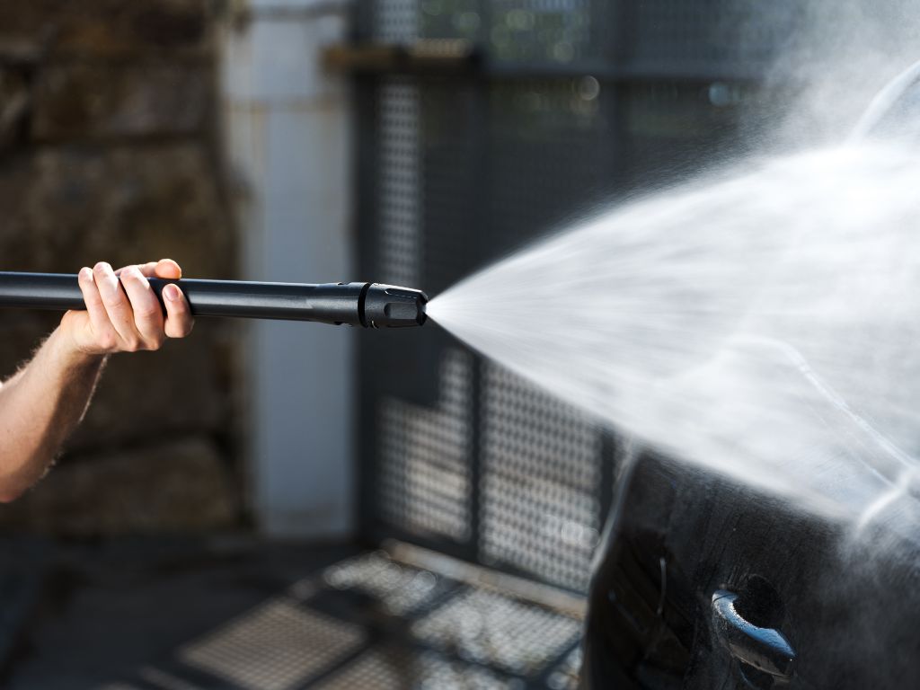 Pressure washer accessory for car and bike by ES, spraying water on a car.