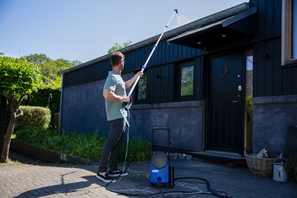 High pressure extension lance by Nilfisk being used to clean a house.
