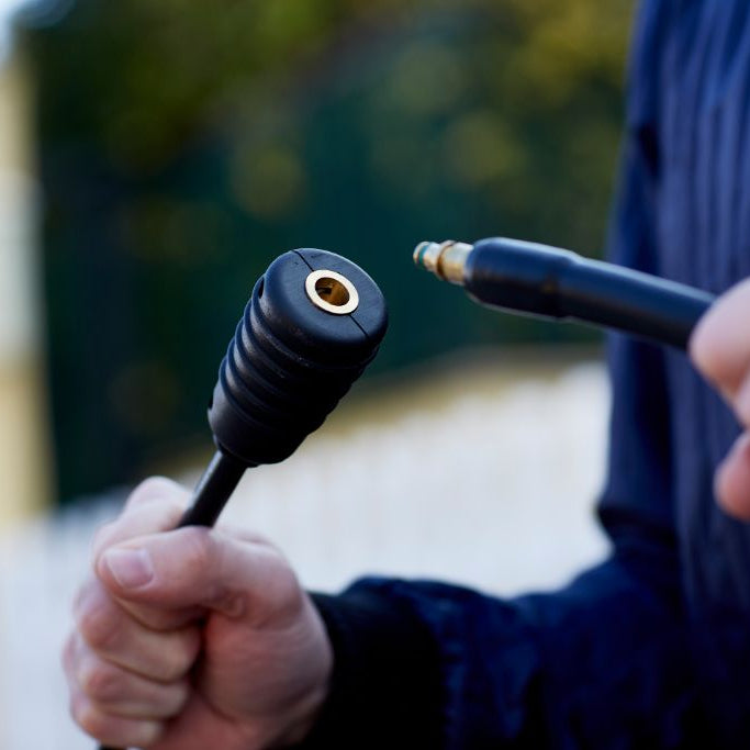 Black pressure washer extension hose for Compact pressure washers, with a visible brass inlet.