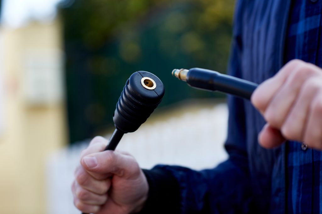 Black pressure washer extension hose for Compact pressure washers, with a visible brass inlet.