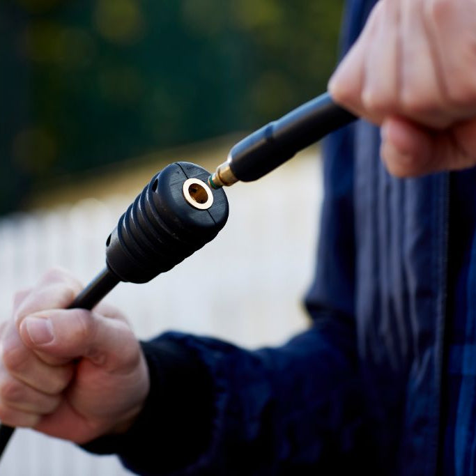 7m steel-armed high pressure washer hose with black textured plastic, being connected to another hose
