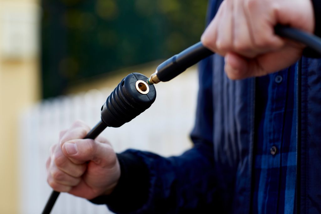 7m steel-armed high pressure washer hose with black textured plastic, being connected to another hose