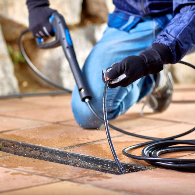 High-pressure cleaner accessory kit by ES DIY for Core 140 high-pressure washers, used to clean a sewer drain.

