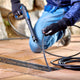 High-pressure cleaner accessory for drains and tubes by UK, with a black hose being inserted into a drain.