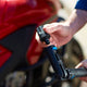 High-pressure washer accessory adapter for high-pressure cleaners, near a red motorbike.