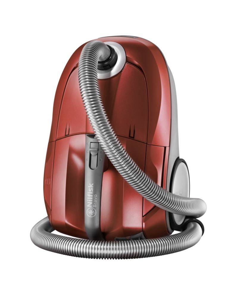 Red canister vacuum cleaner by Nilfisk with a coiled silver hose and silver accents.
