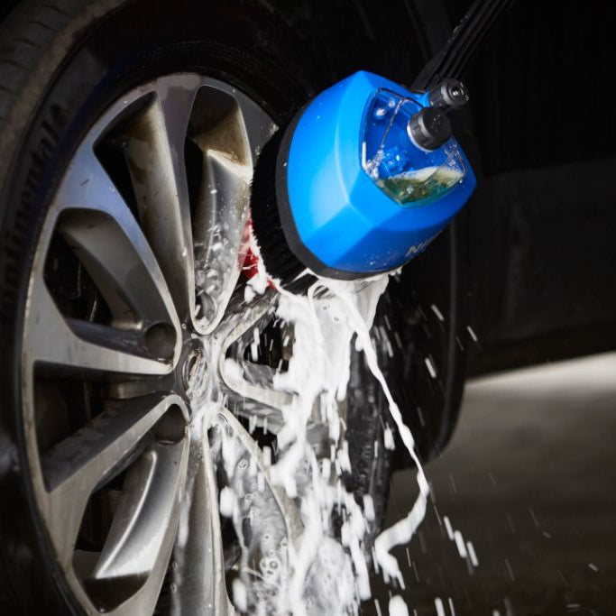 High-pressure cleaner cleaning agent by ES, seen washing a car wheel with foam.
