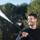 Pressure washer by ES shooting a jet of water outdoors.