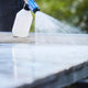 Pressure washer cleaning fluid by Nilfisk, being sprayed onto a surface from a foaming nozzle.