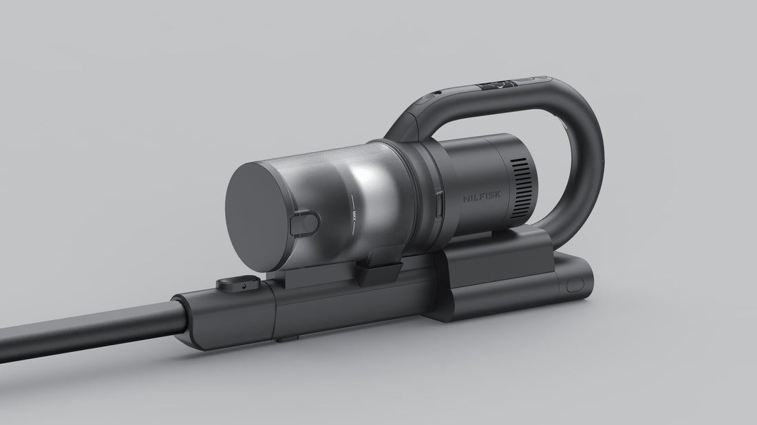 Sleek black Nilfisk handheld vacuum with silver dustbin, curved handle, and extendable wand on neutral gray background.