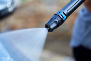 High-pressure washer attachment for pressure washers with a close-up water spray pattern.