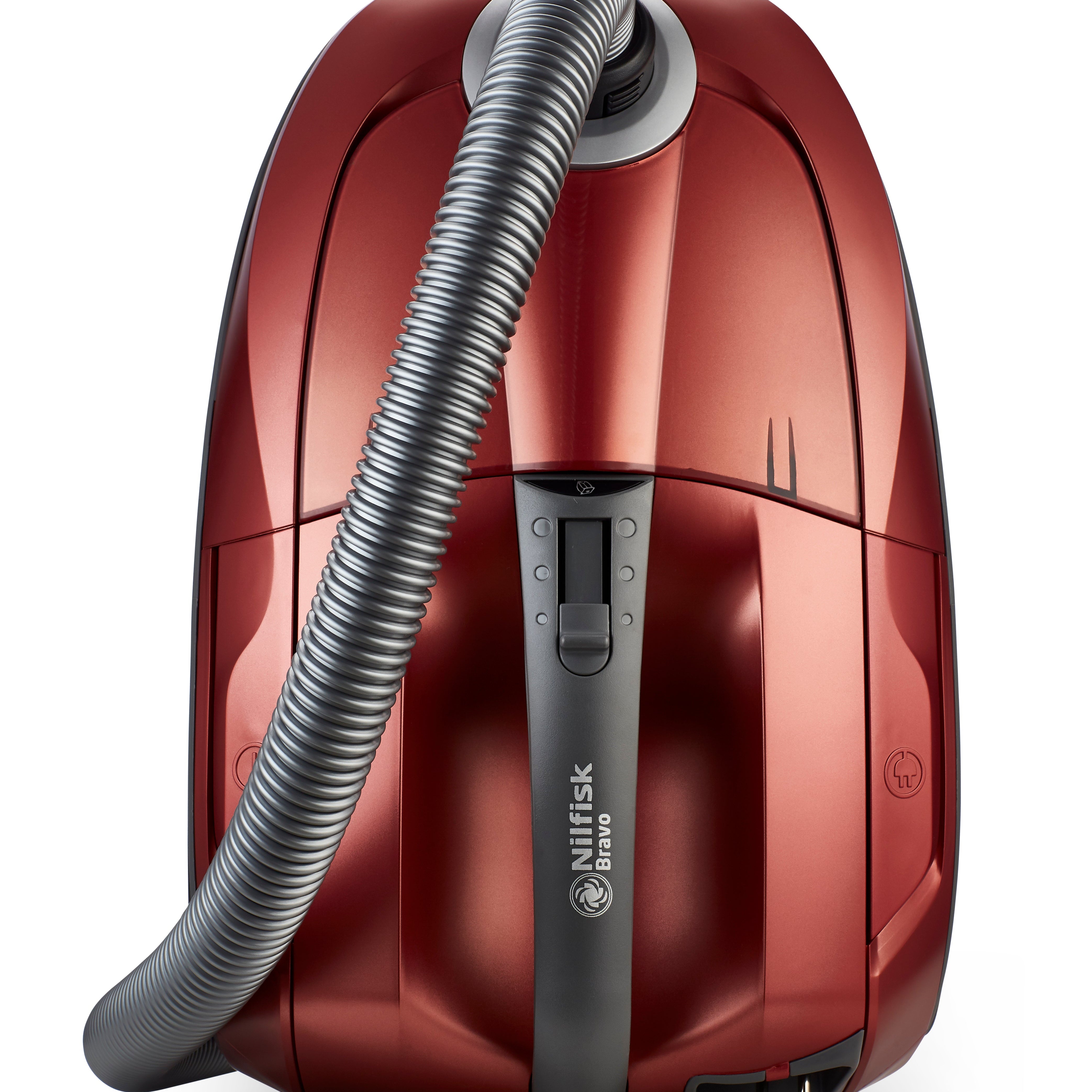 Red canister vacuum cleaner by Nilfisk, featuring a gray hose, and a streamlined design with a metallic finish.