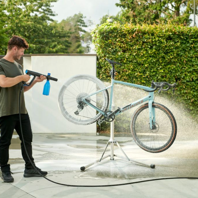 High-pressure washer with multi-functional nozzle by ES Excellent, used outdoors for bicycle washing.